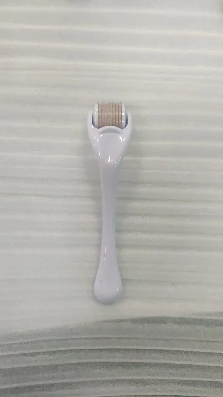 Sterile 540 micro needle derma roller showing handle and needle wheel in assorted colours.