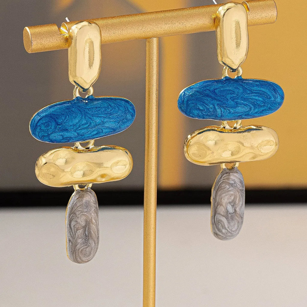 A pair of geometric stud earrings with a multicolour electroplated finish on a zinc alloy base.