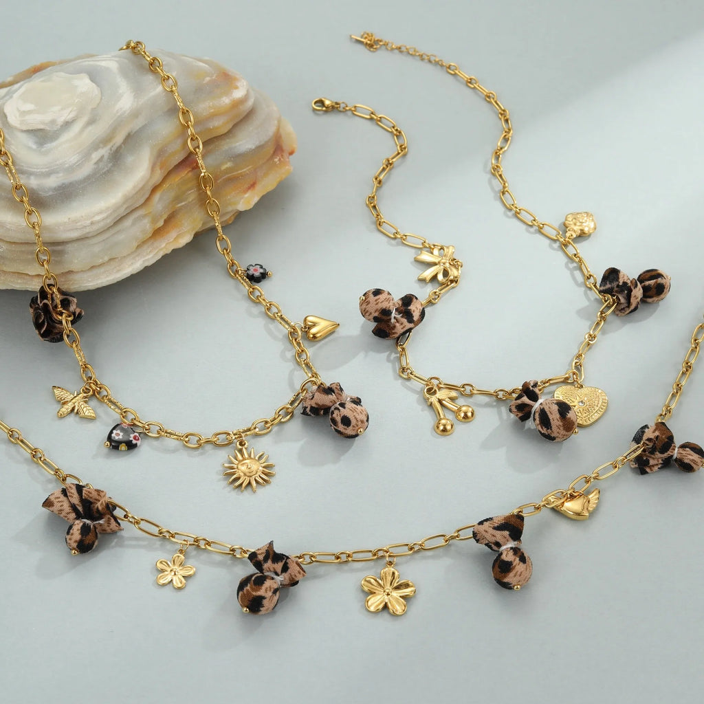 Geometric pendant stainless steel necklace with leopard, love heart and flower designs on adjustable chain
