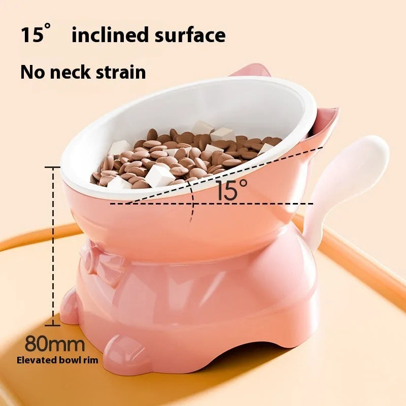 A slanted stainless steel cat bowl in yellow, shown from a side angle on a plain surface.