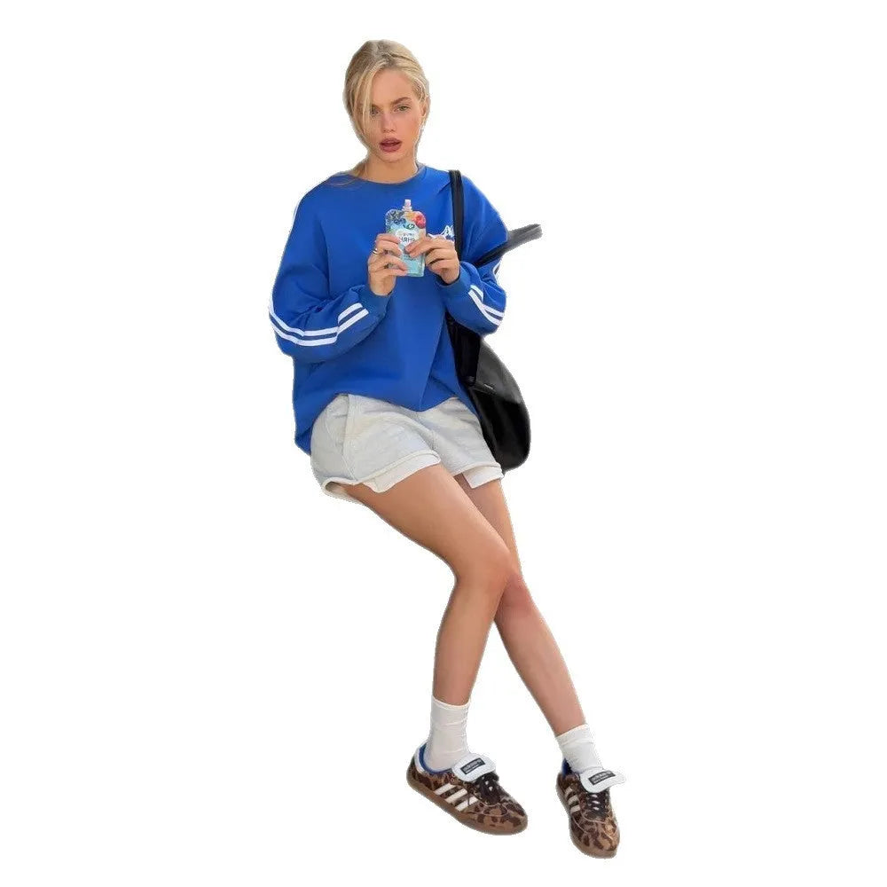 Blue and white vintage stripe loose-fit cotton-blend pullover sweater on a hanger.