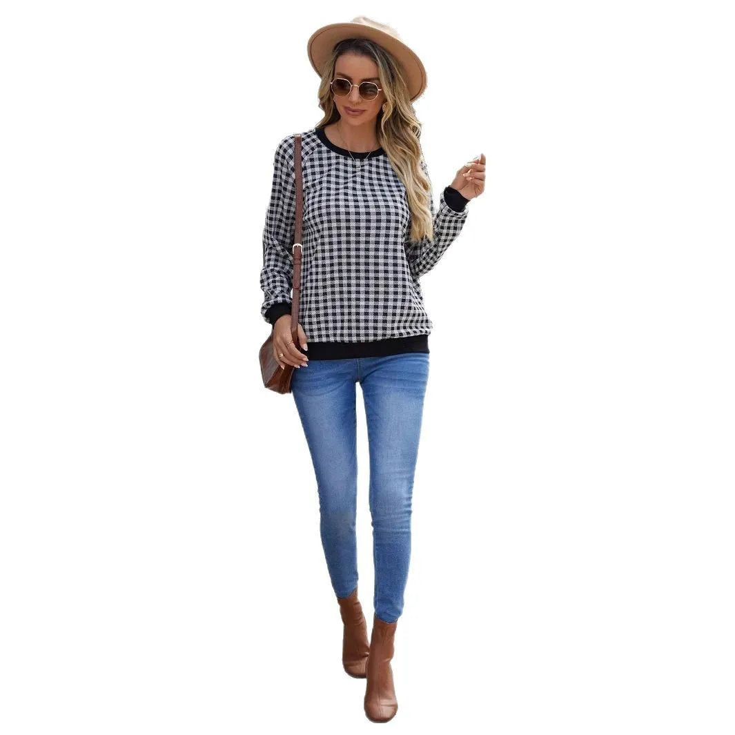 Black plaid print pullover sweater with long sleeves on mannequin