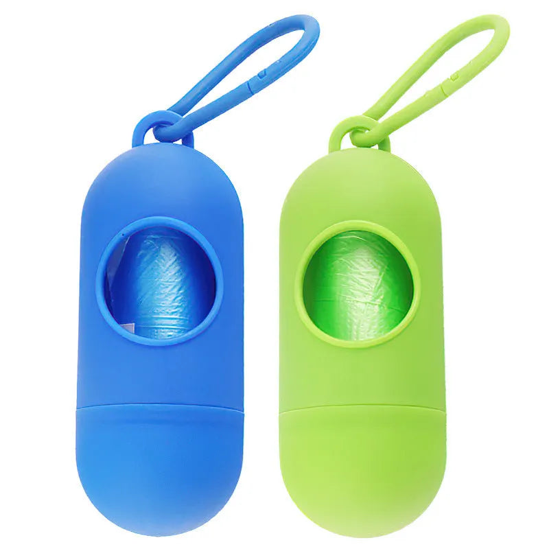 Small black dog waste bag holder with a side clip and Velcro strap, shown next to a roll of poop bags.