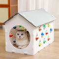 House-shaped cat scratch board with integrated bell ball and tunnel for indoor cats