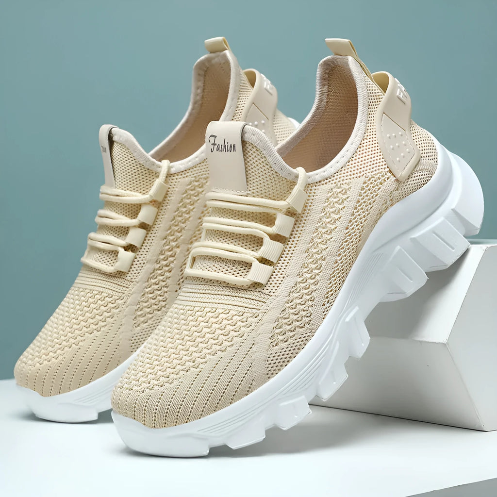 Women's white Flyknit running sneakers with lace-up front and thick PVC sole on a neutral background.