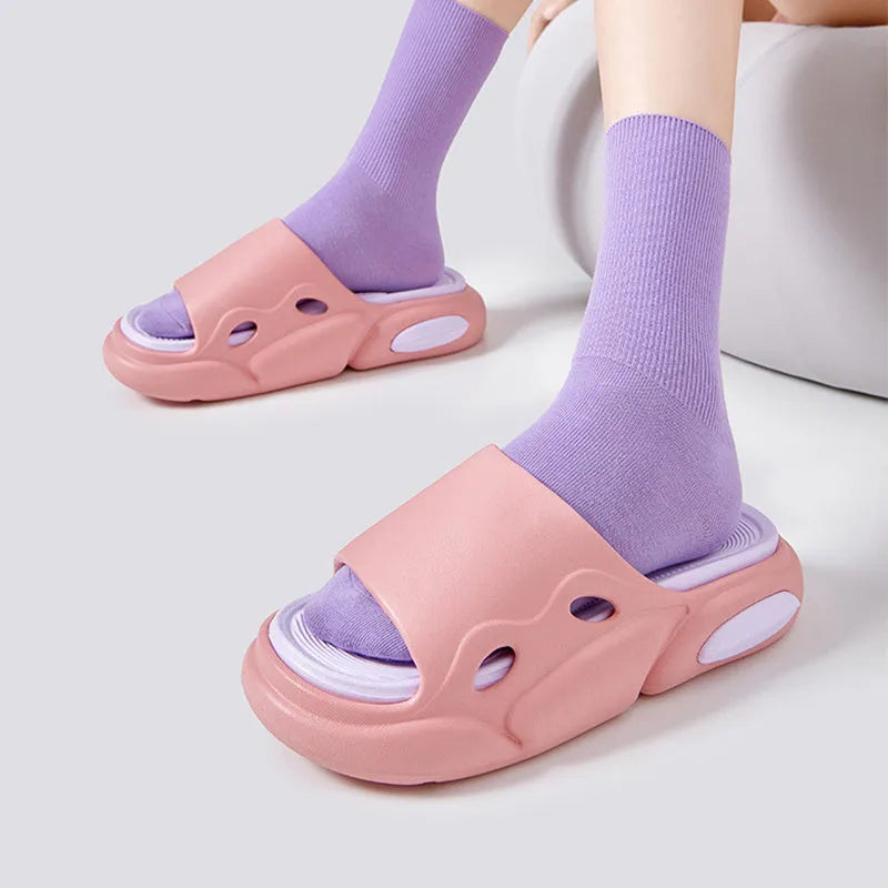 Women's two-colour EVA slippers with thick sole and leather lining in pink purple, shown on a foot.