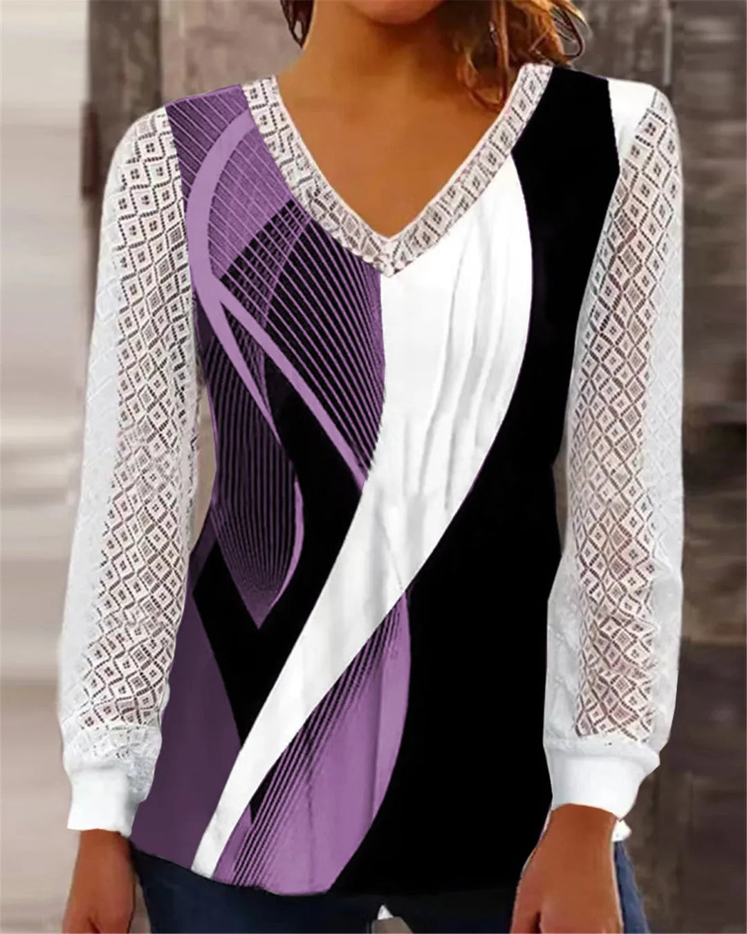 Women's loose V-neck lace top in purple with long sleeves, shown on a hanger.