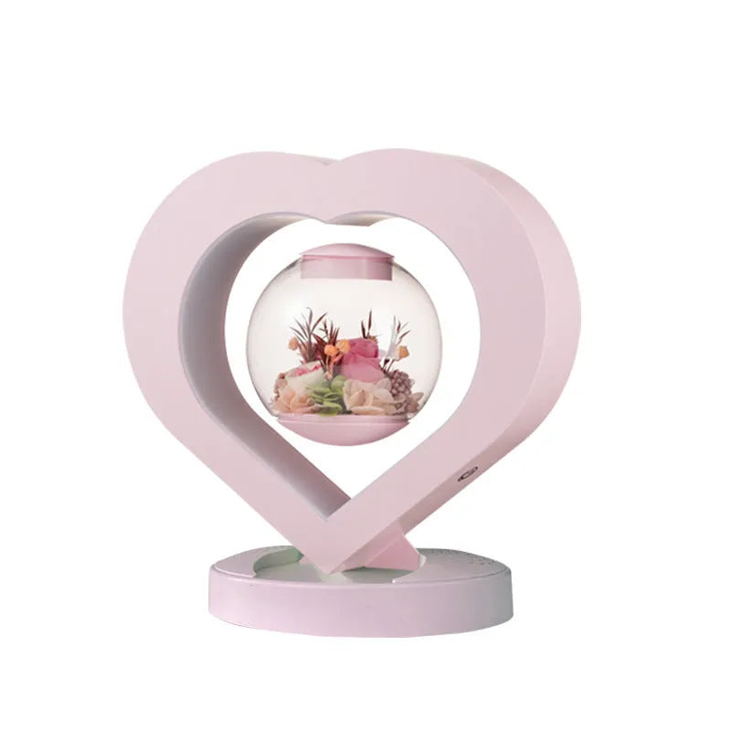 Pink preserved rose inside clear acrylic heart ornament with optional Bluetooth speaker base
