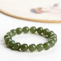 Polished Hetian jade ball bracelet in ice-like clear colour on a white background.