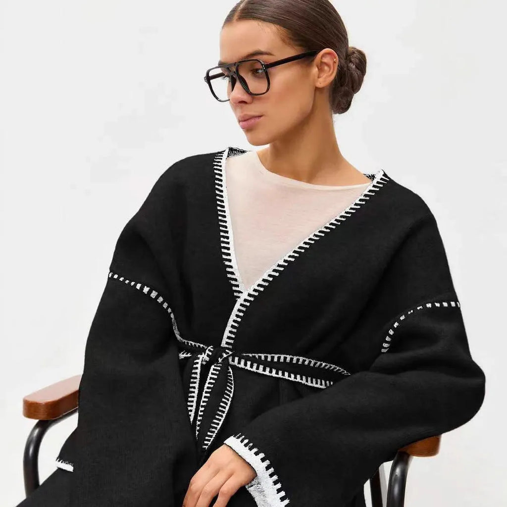 Loose fit knitted cardigan sweater in black, camel, or white colour on a hanger