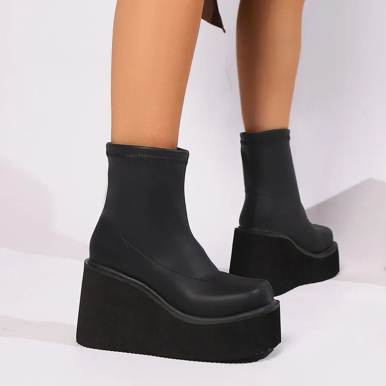 Plus size black women's wedge heel boots with a waterproof platform and round toe.