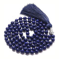 Long multi-stone agate and amethyst tassel necklace with blue pattern, geometric beads.