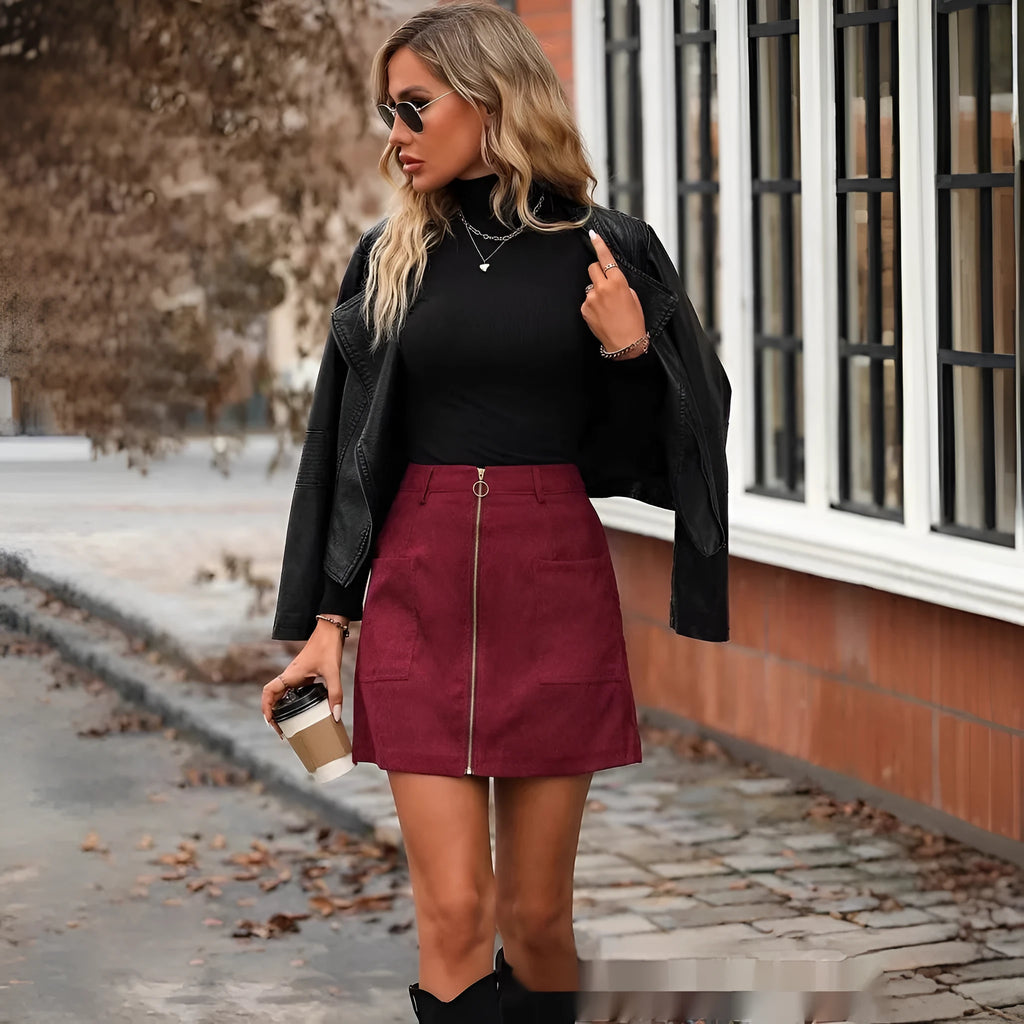 Women's high waist short skirt in black with front stitching detail and zipper.