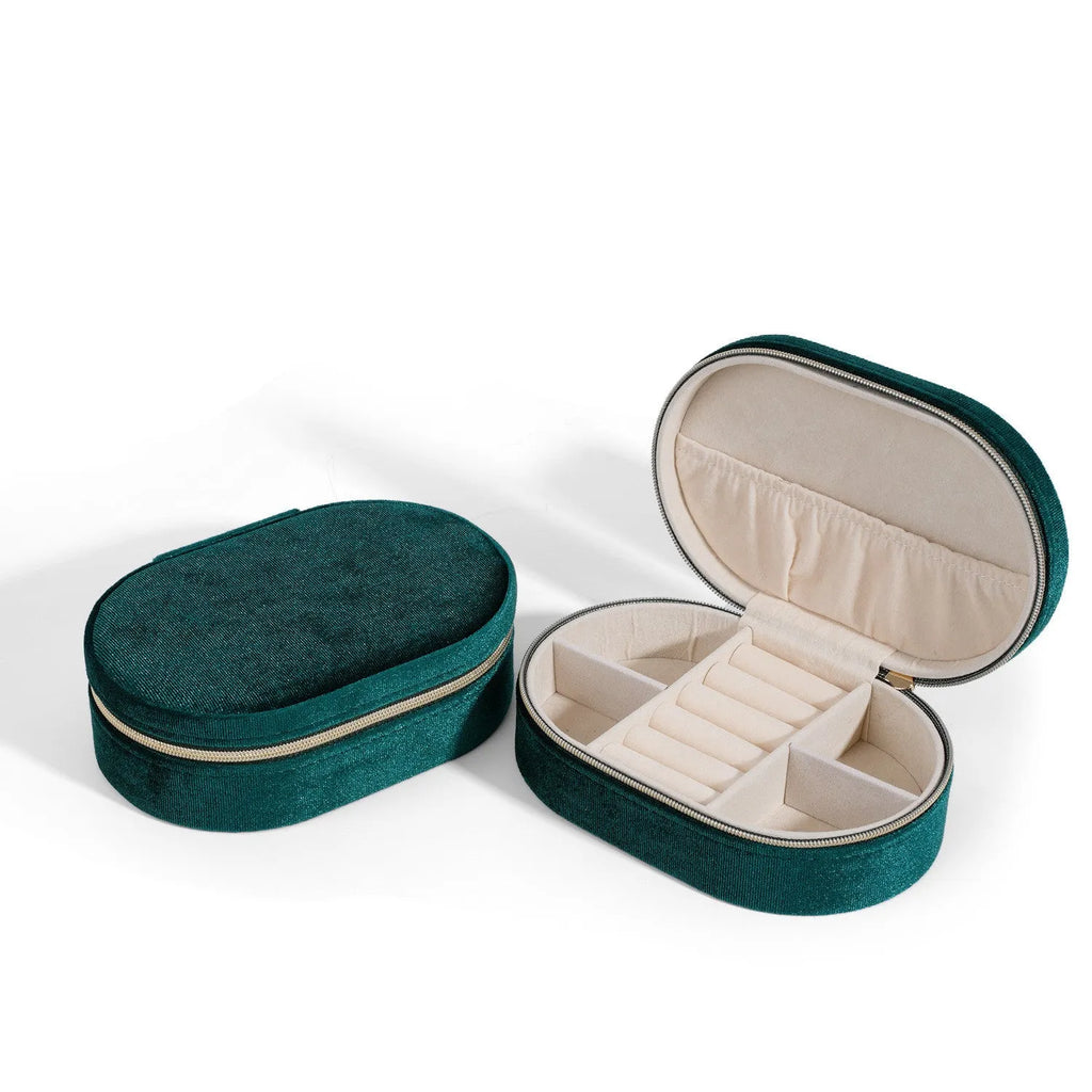 Oval shaped velvet jewellery storage box in lake blue colour with internal compartments and a red hook.