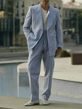 Blue and white striped polyester blazer and trousers suit set on a hanger.