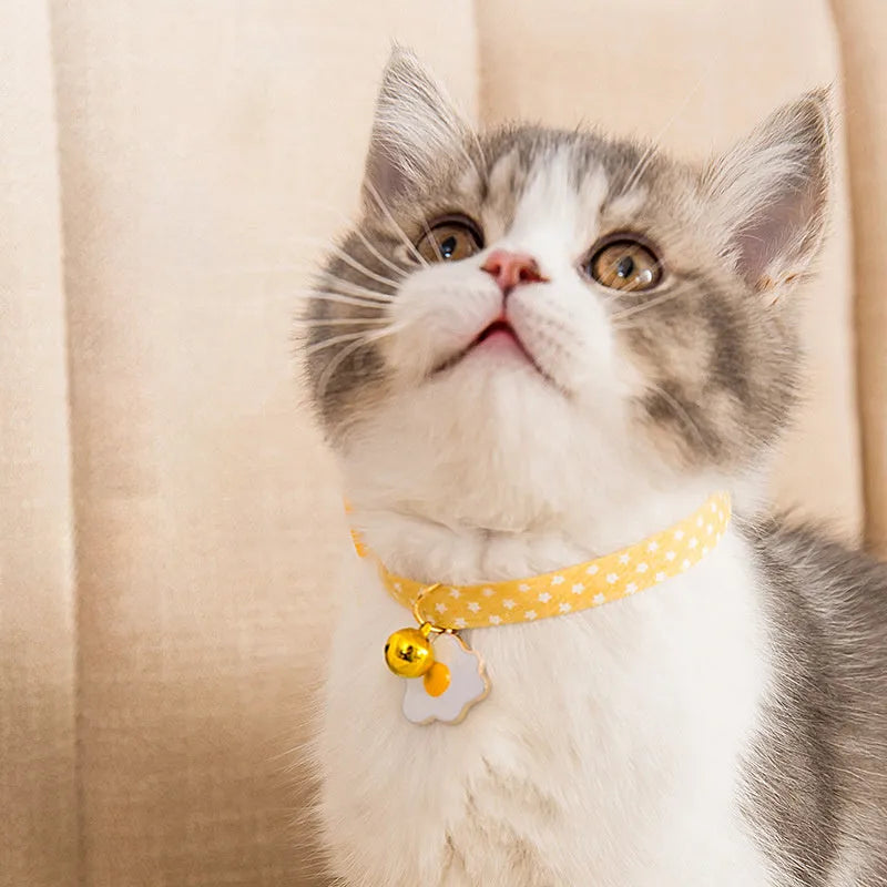 Green adjustable cat collar with metal bell pendant and matching bow tie accessory for small pets