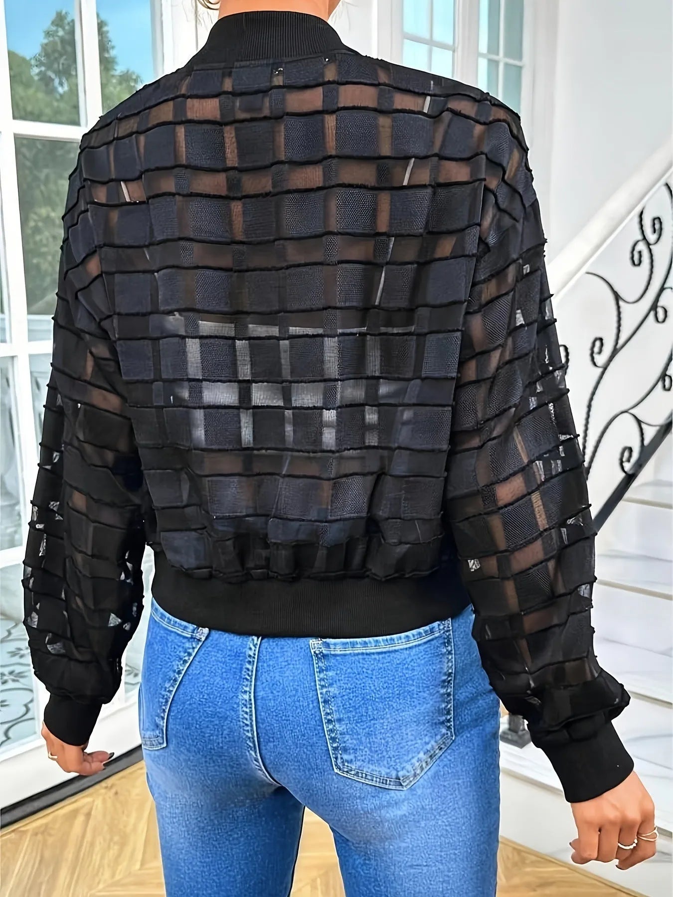 Black women's casual zip jacket with a geometric pattern on semi-transparent polyester fabric.