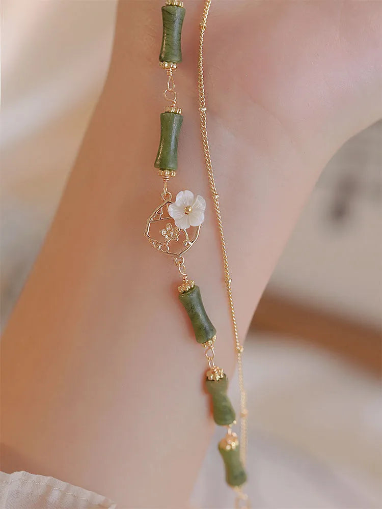 Handcrafted green olivine bracelet with double layer twin bells and olive branch design.