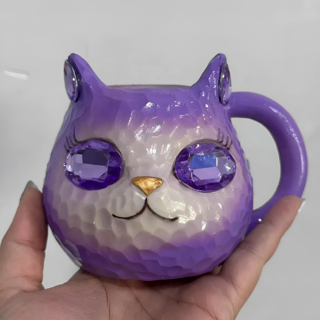 Decorative resin cat cup paperweight in American crafts style, shown in purple, green, blue, and pink colour options.