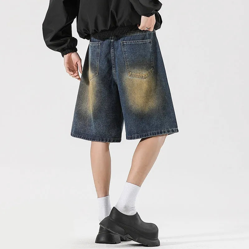 Men's loose fit ripped jeans in retro blue denim with distressed detailing and street style design