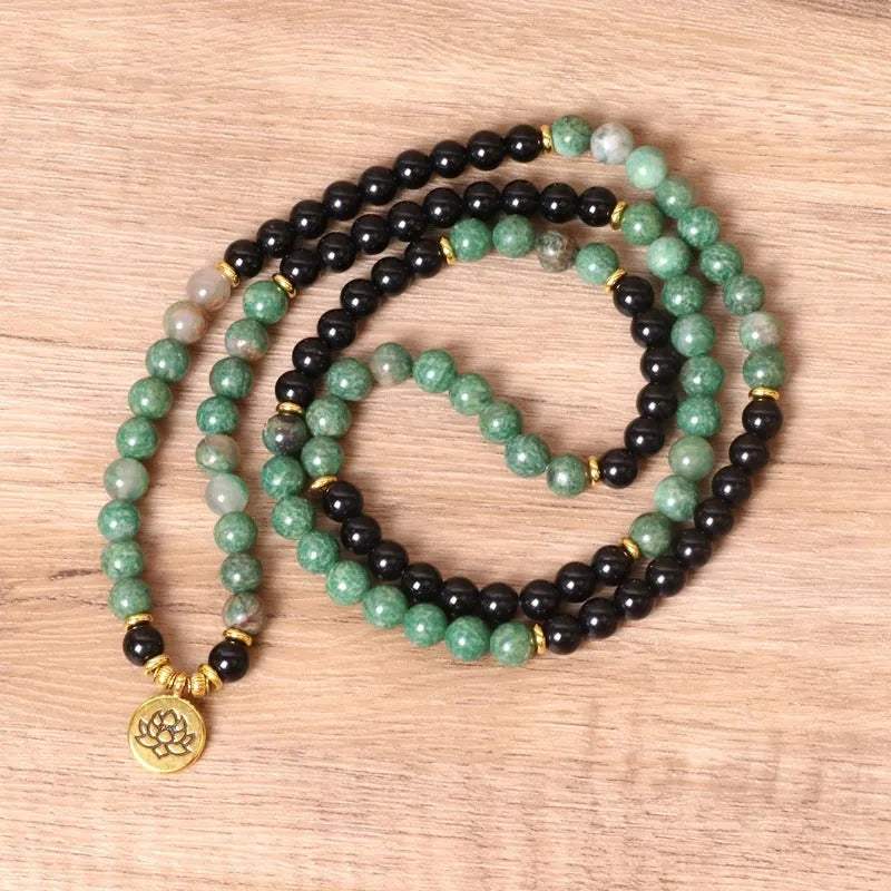 Green and black alloy beaded bracelet on an elastic cord