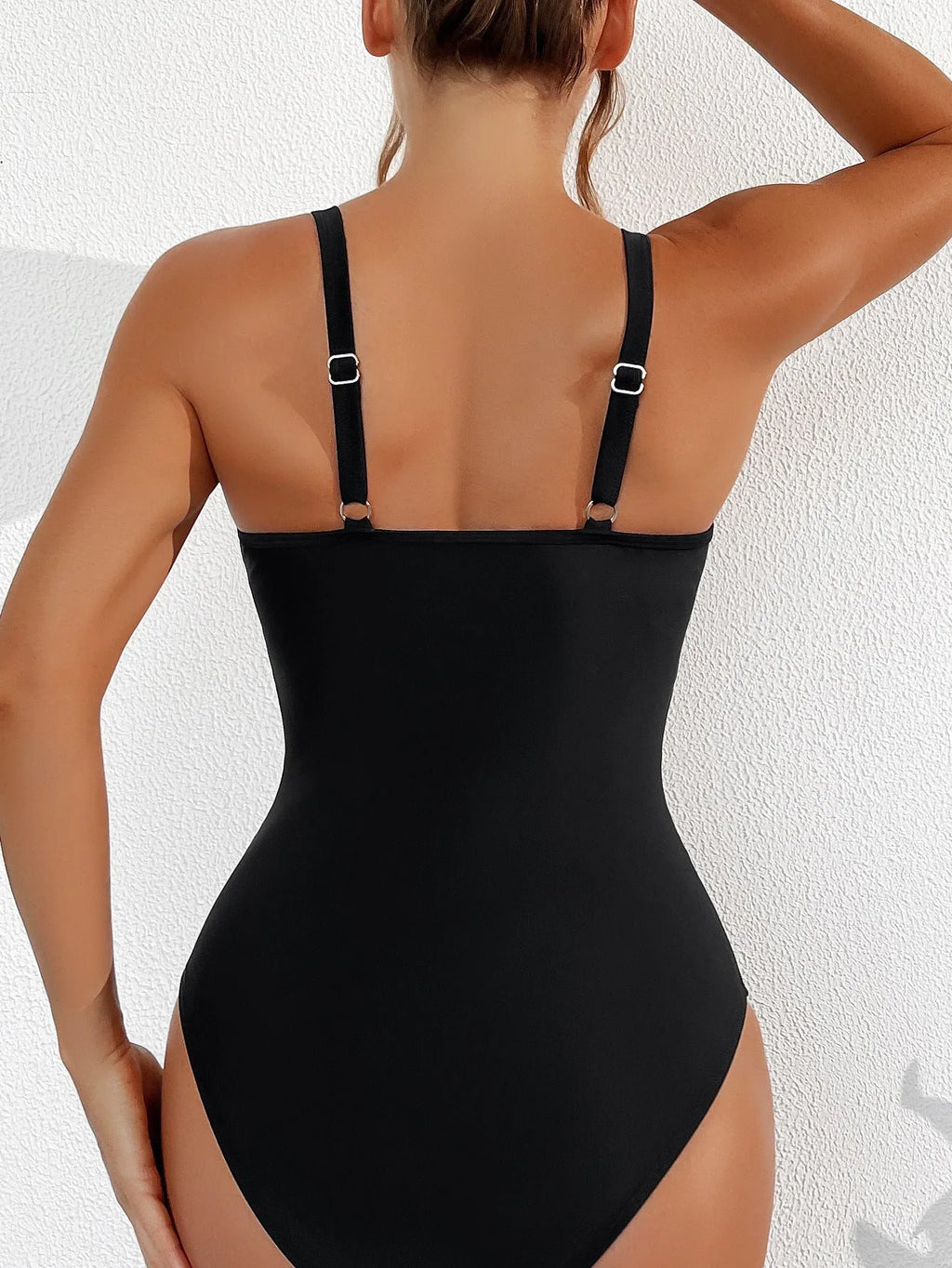 Black women's one-piece halter swimsuit with mesh detailing and brief-style bottom.