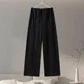 Women's black polar fleece trouser suit set with pleated long sleeve top and wide-leg pants on a hanger.