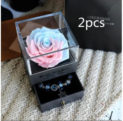 Eternal flower gift box with preserved roses and carnations inside a decorative presentation case.