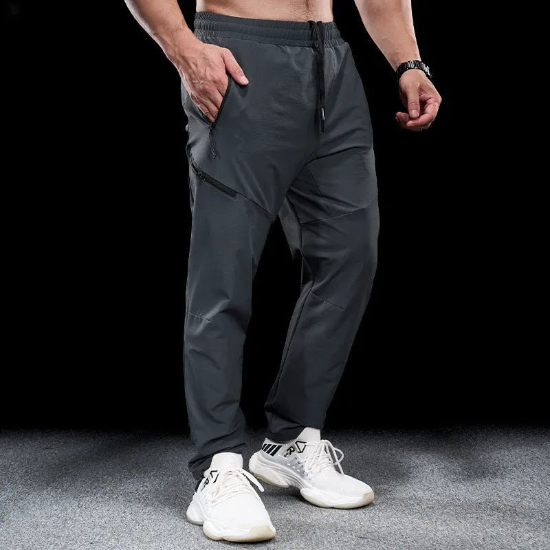 Men's black waterproof quick-drying nylon workout pants for sports and exercise.