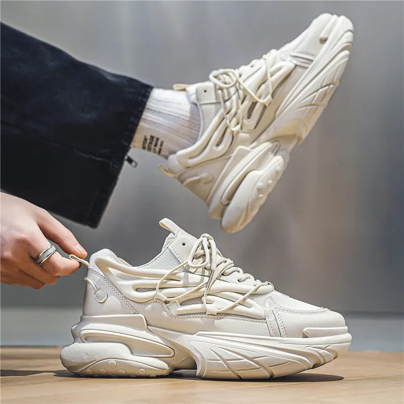 Men's beige and black low-top sneakers with mesh lining, lace-up front, and rubber platform soles