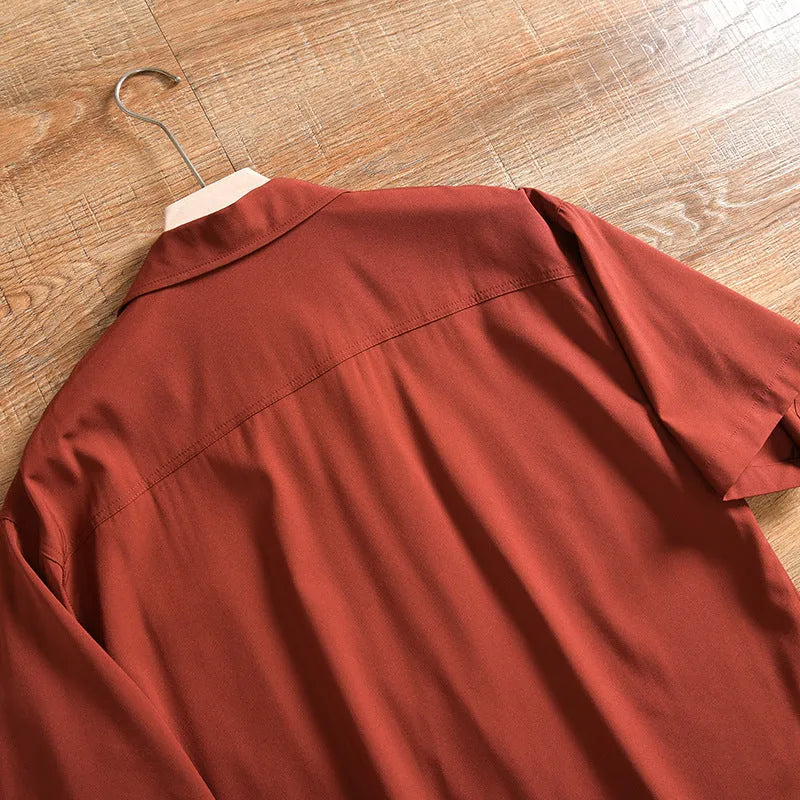 Man wearing a loose-fitting, solid colour short sleeve shirt in a Japanese fresh cardigan style.