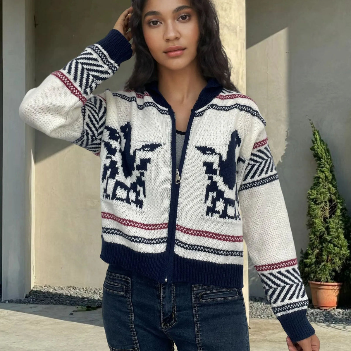 White women's zip cardigan with lapel collar and jacquard contrast colour stripes laid flat.