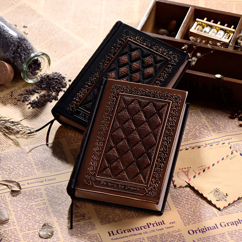 Bronze embossed faux leather A5 notepad with 192 thick unlined pages, lying open.