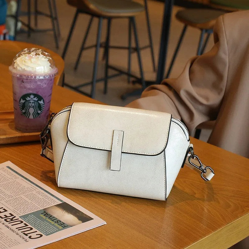 Women's brown oil wax cowhide shell-shaped crossbody messenger bag with visible stitching