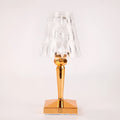 Rose gold portable touch control night light with acrylic lamp holder on a wooden surface.