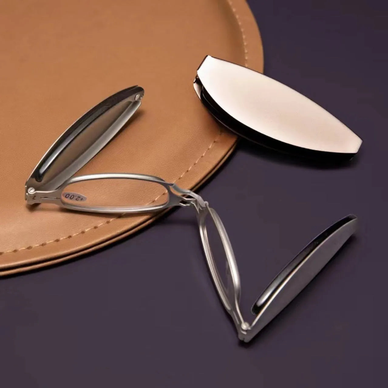 Folding pocket presbyopic glasses with retro ring-style metal frame in black or silver colour options.