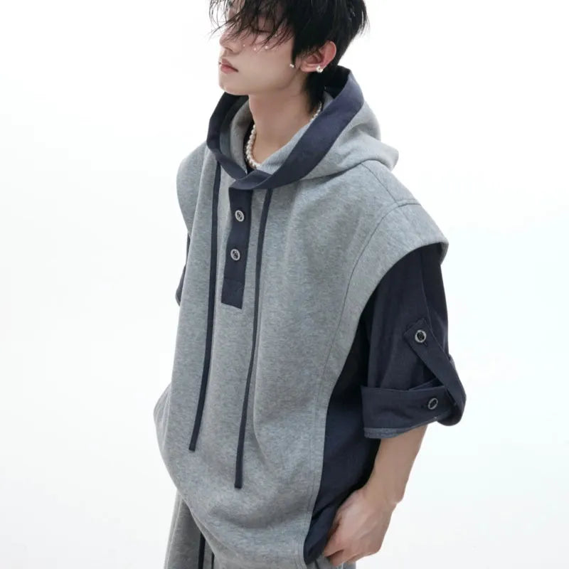 Men's black heavy industry sports suit with hooded short sleeve jacket and trousers laid flat.