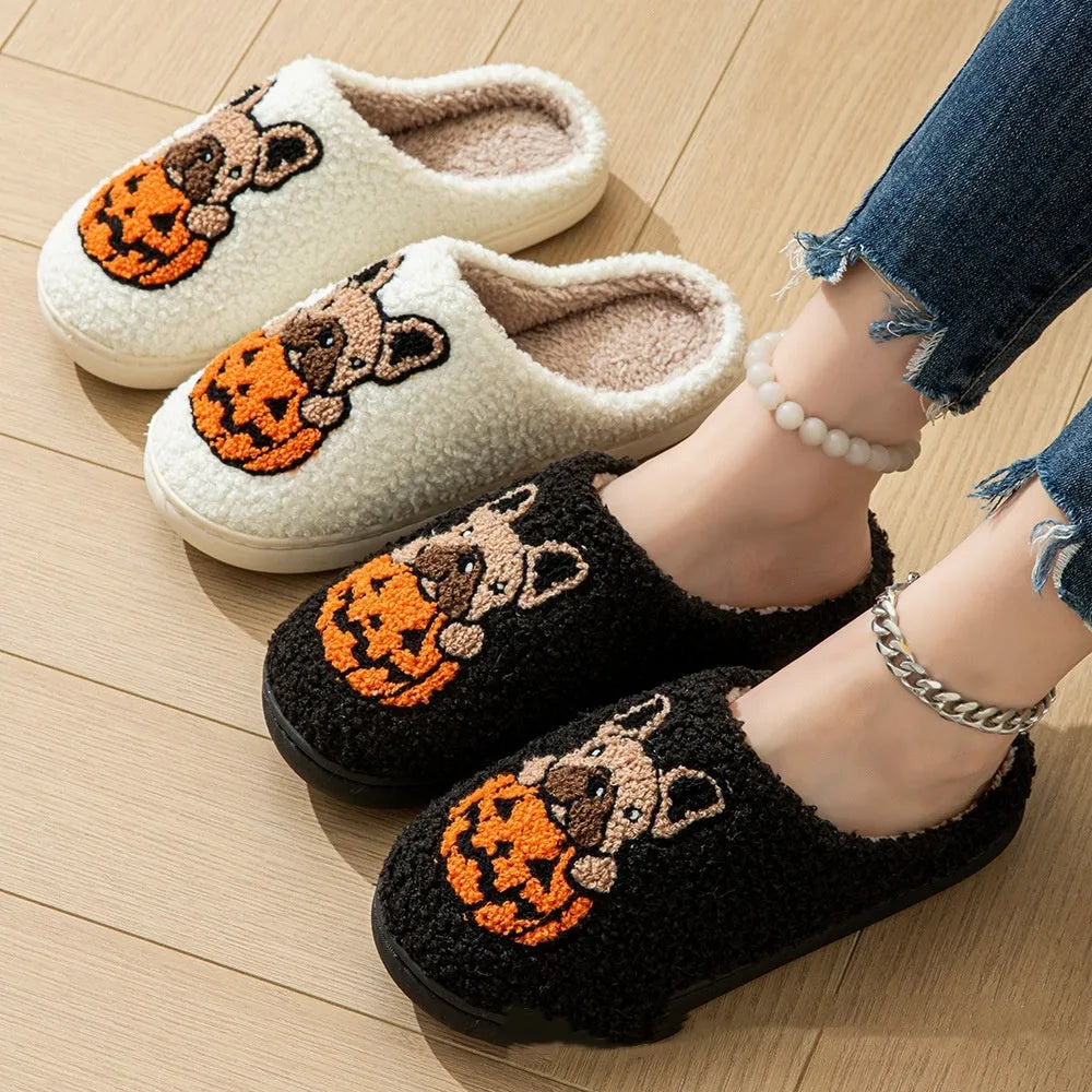 A pair of black and white Halloween-themed plush house slippers with rubber soles.