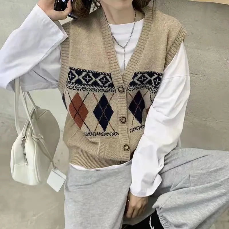 Diamond plaid pattern sleeveless cardigan top in khaki colour, laid flat.