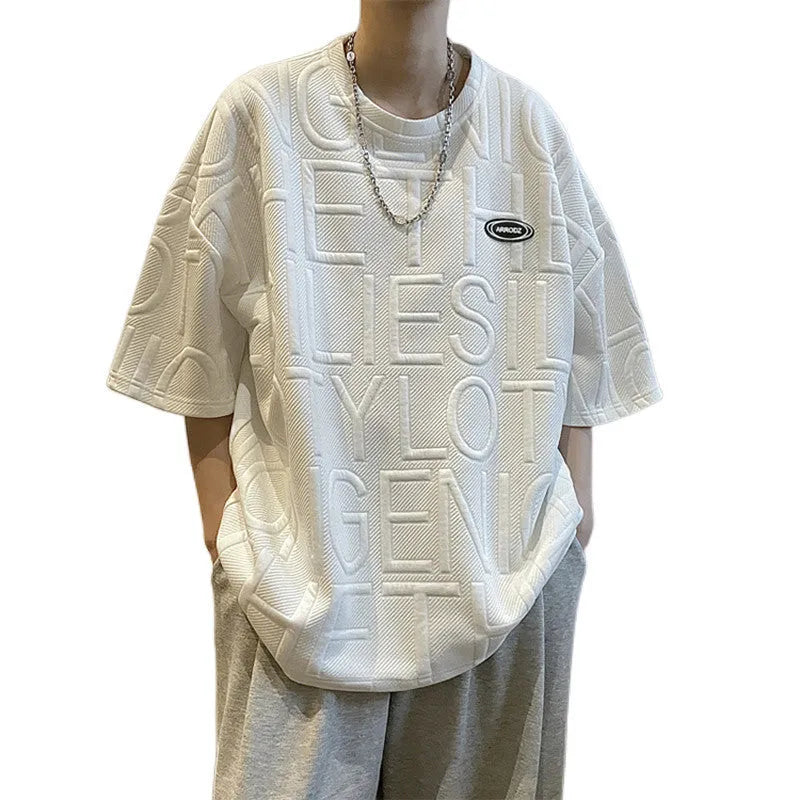 Men's loose fit grey t-shirt with a raised black three-dimensional retro letter print on the front.
