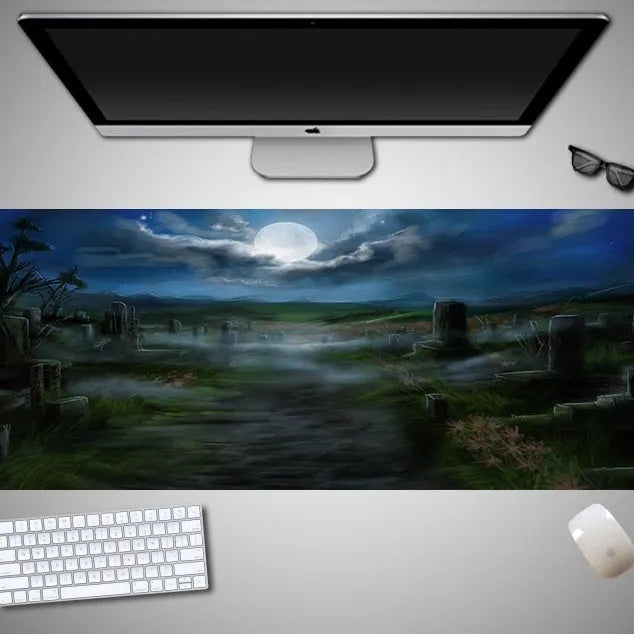 Oversized rectangular Halloween-themed mouse pad on a desk, showing one of 28 graphic designs.