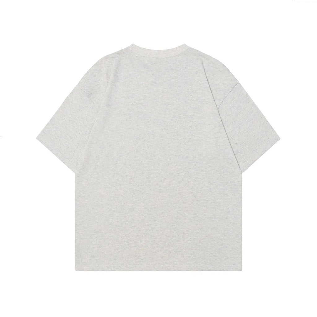 Man wearing a black loose-fit cotton t-shirt with a retro character design print on the front.