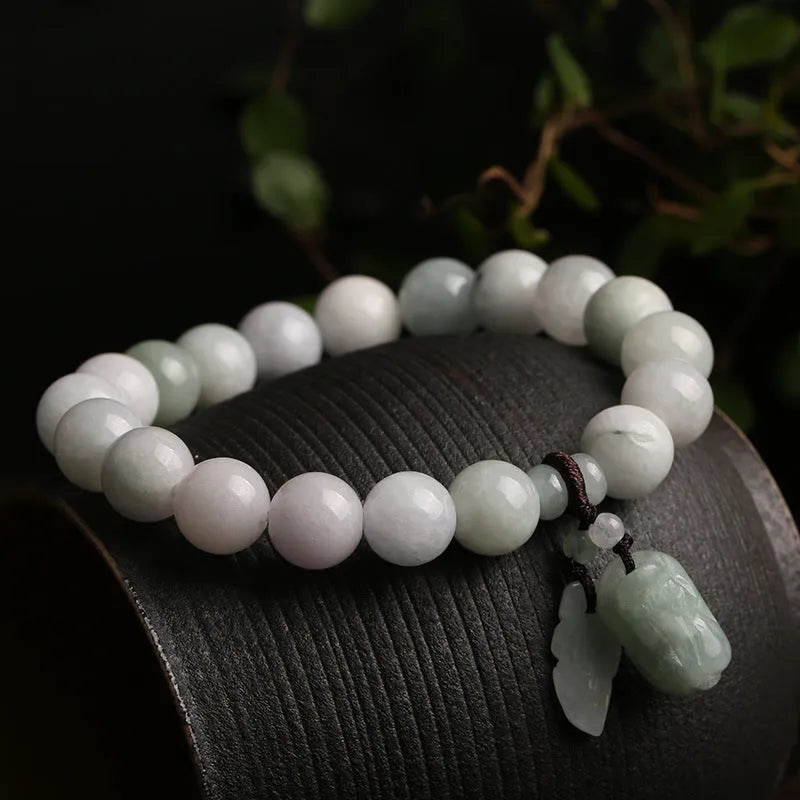 Natural emerald jade bracelet with hanging geometric beads and Buddhist elements