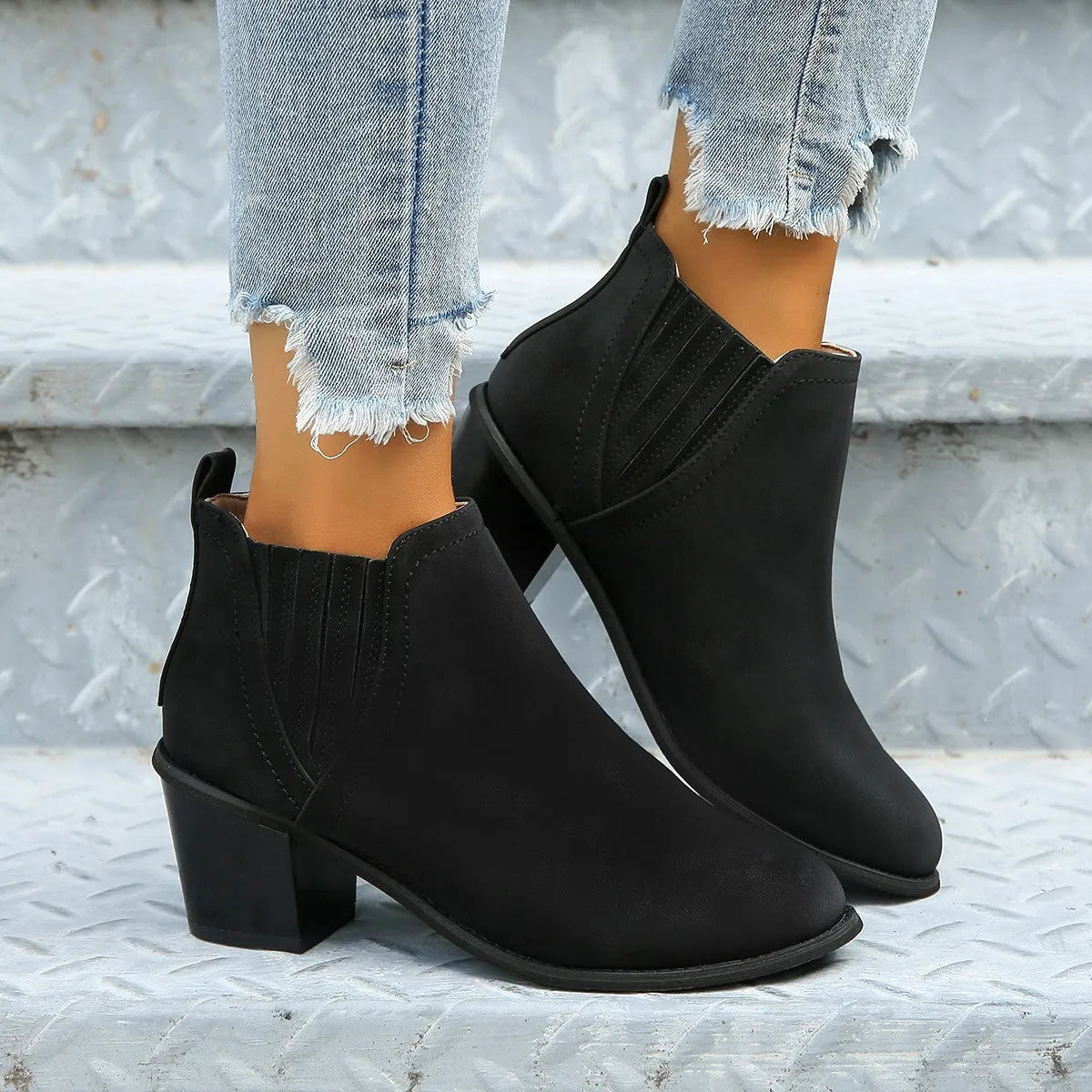 Women's black pointed toe ankle boots with thick square low heel and slip-on design