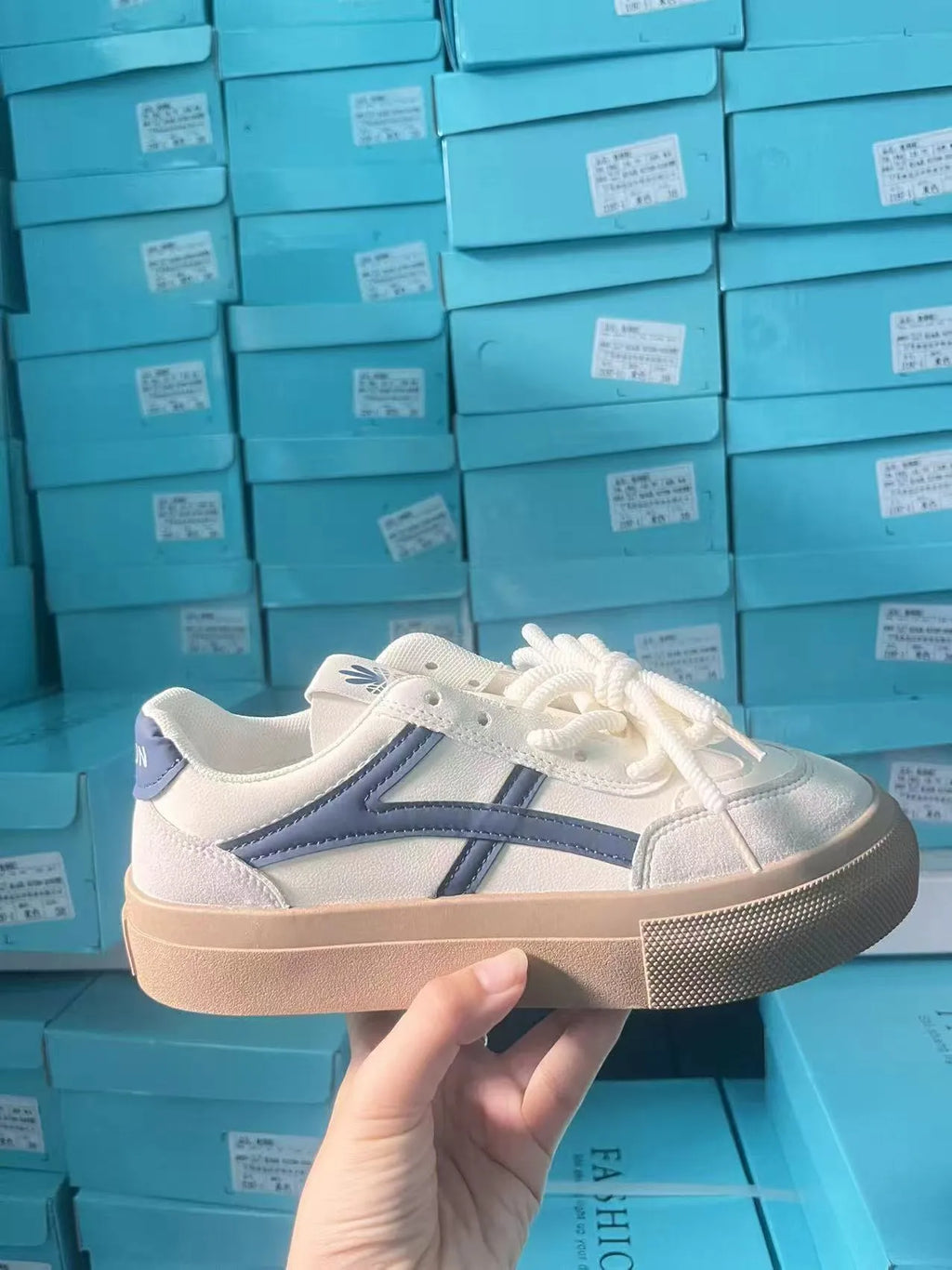Women's brown and blue lace-up casual trainers with a patent leather-look PU upper and rubber sole.