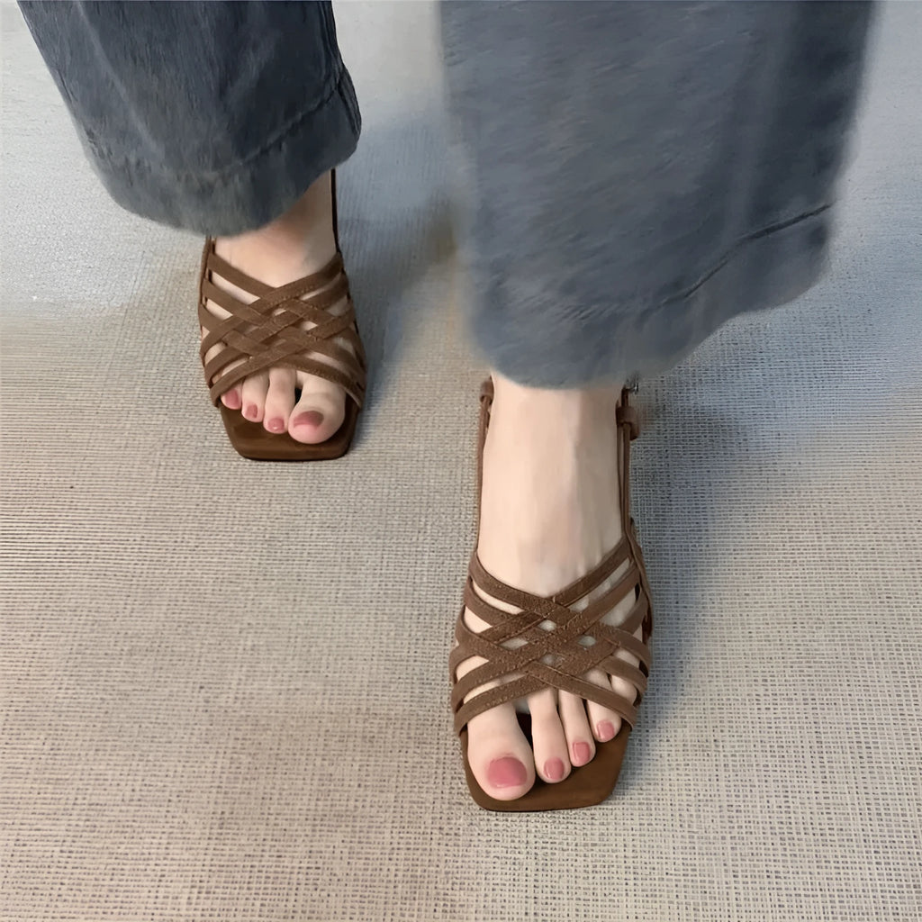 Retro light brown women's sandals with thin cross straps, square toe, ankle buckle, and a mid-height heel.