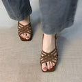 Retro light brown women's sandals with thin cross straps, square toe, ankle buckle, and a mid-height heel.