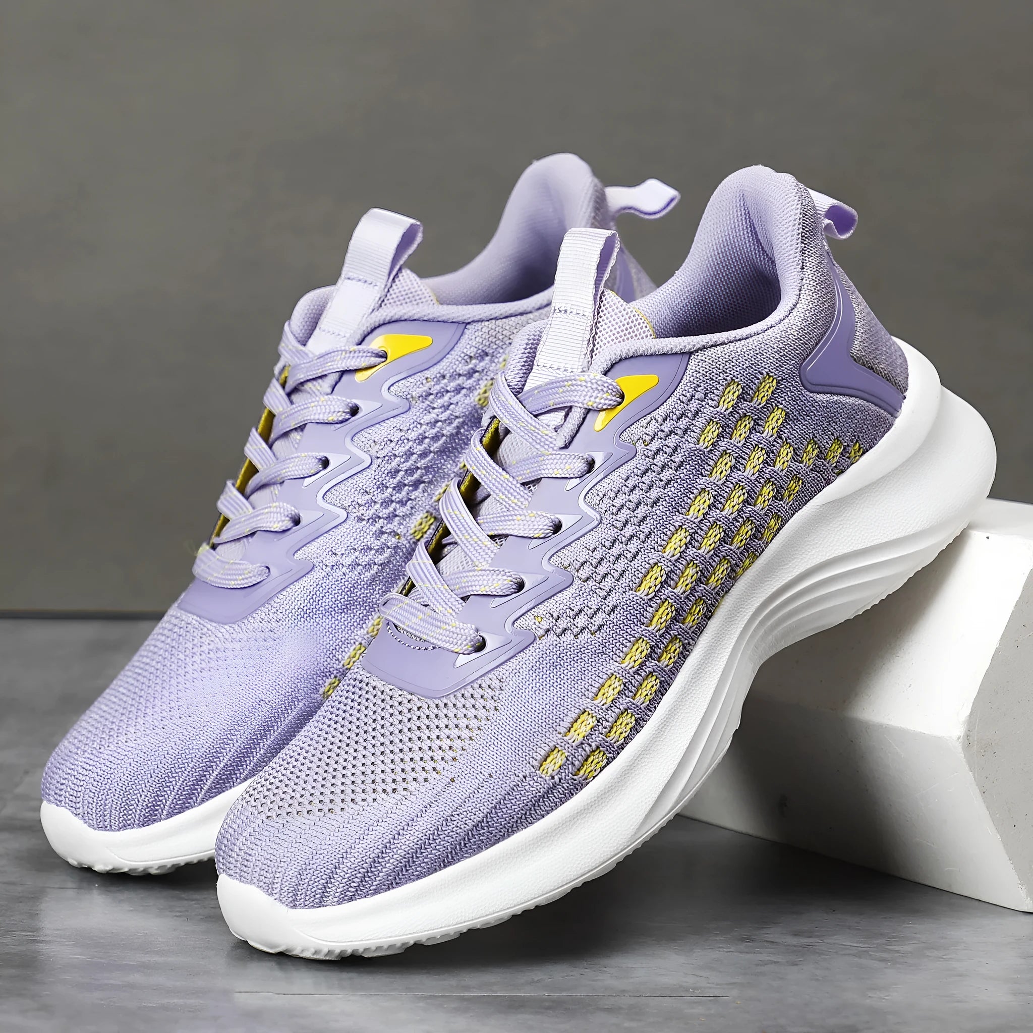 Women's lavender purple Flyknit running shoes with striped pattern and mesh upper on a white background.
