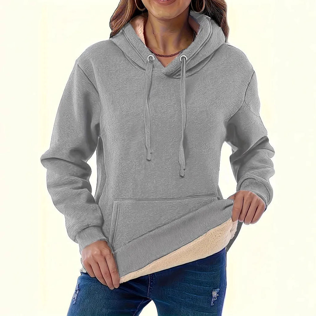 Women's loose black hooded sweater with pockets and a 3D textured pattern, long sleeves.