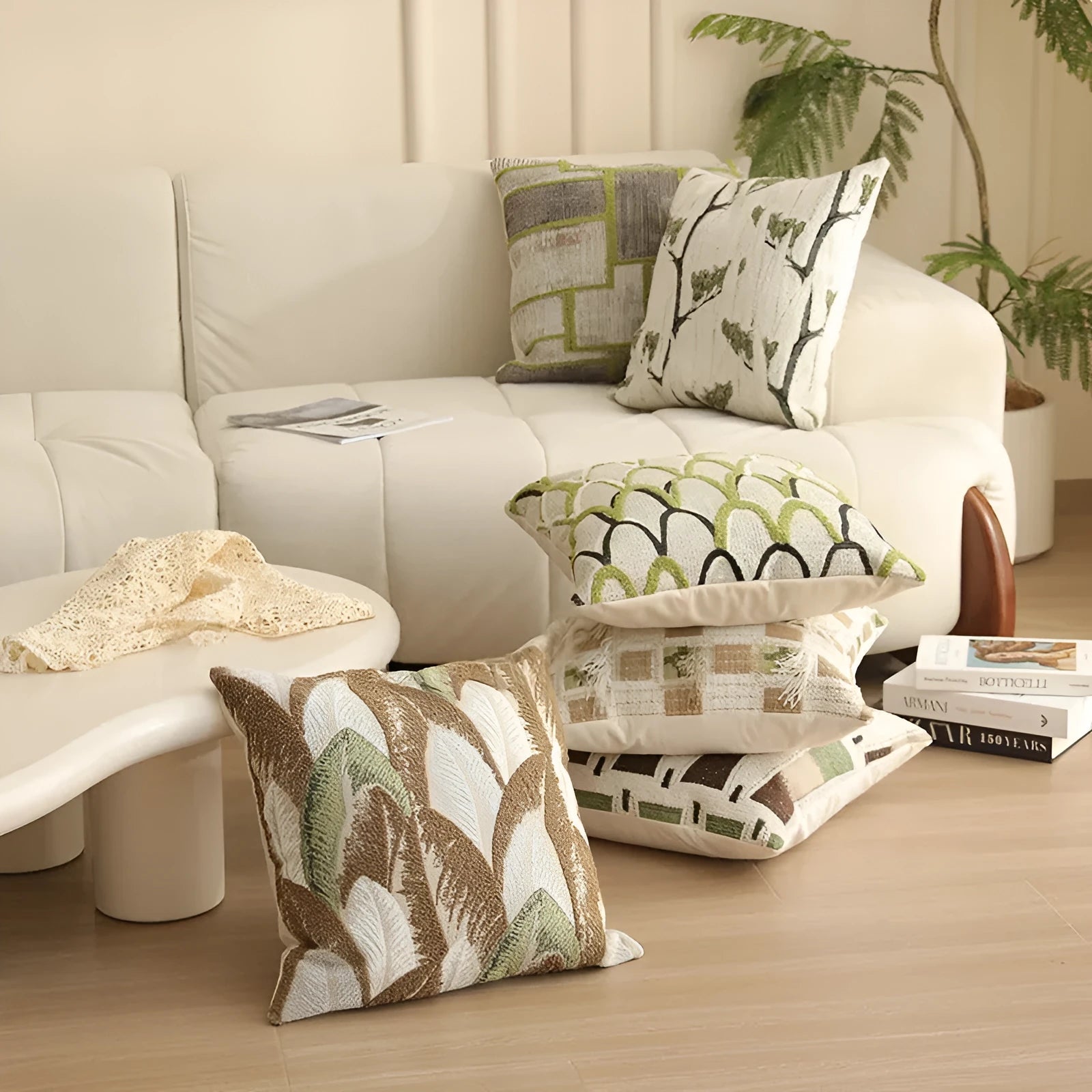 Square jacquard pillow cover with botanical pattern on a sofa, showing one of eight available colour options.